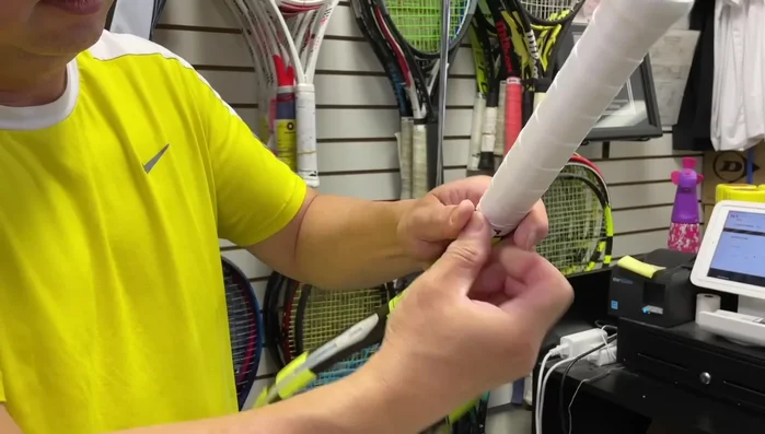 Use the finishing tape to secure the folded end, ensuring a neat and professional finish.