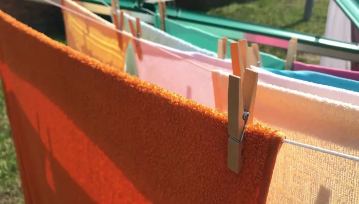 If air drying, hang towels outside in a well-ventilated area, shaking them out first.