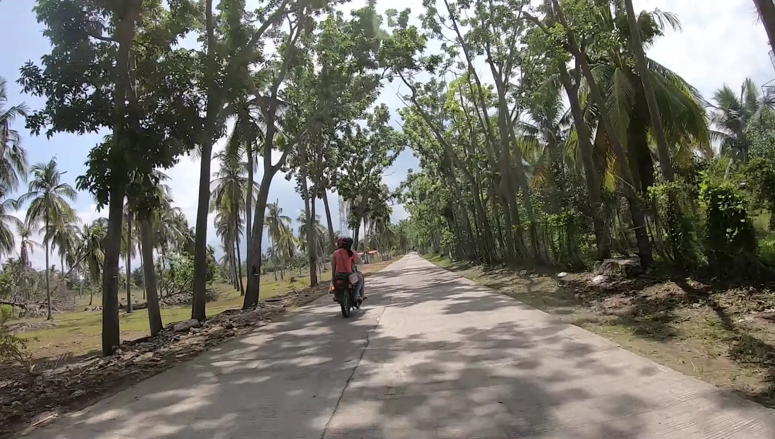 The YouTuber on a motorbike approaching a remote court.