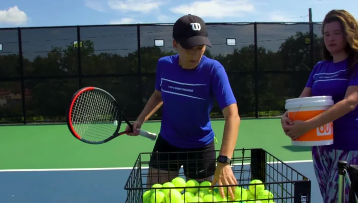 The Deluxe Club Cart's elevated design provides comfortable access to balls, alleviating back strain, particularly beneficial during long coaching days.