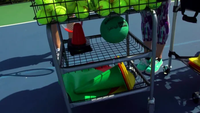 The Deluxe Club Cart's elevated design provides comfortable access to balls, alleviating back strain, particularly beneficial during long coaching days.