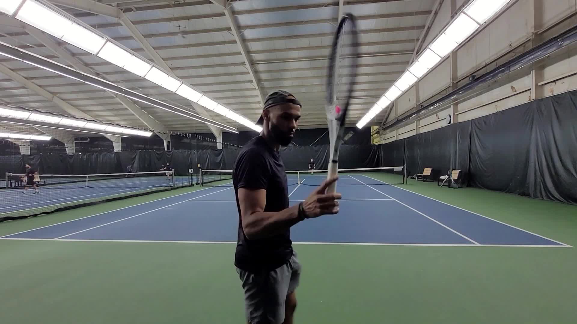 Close-up of the HEAD Speed Midplus racquet showcasing its glossy black and white finish.