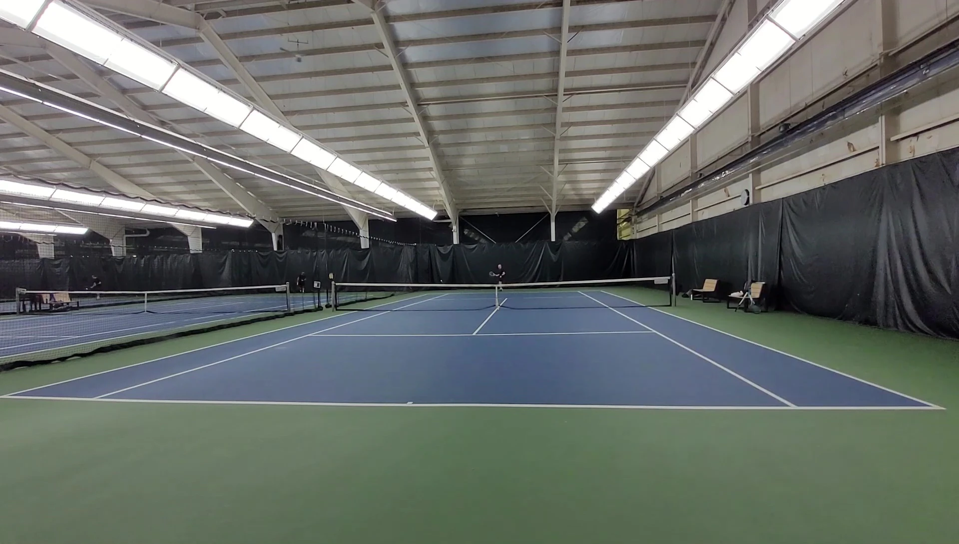 The reviewer holding and demonstrating the HEAD Speed Pro racquet.
