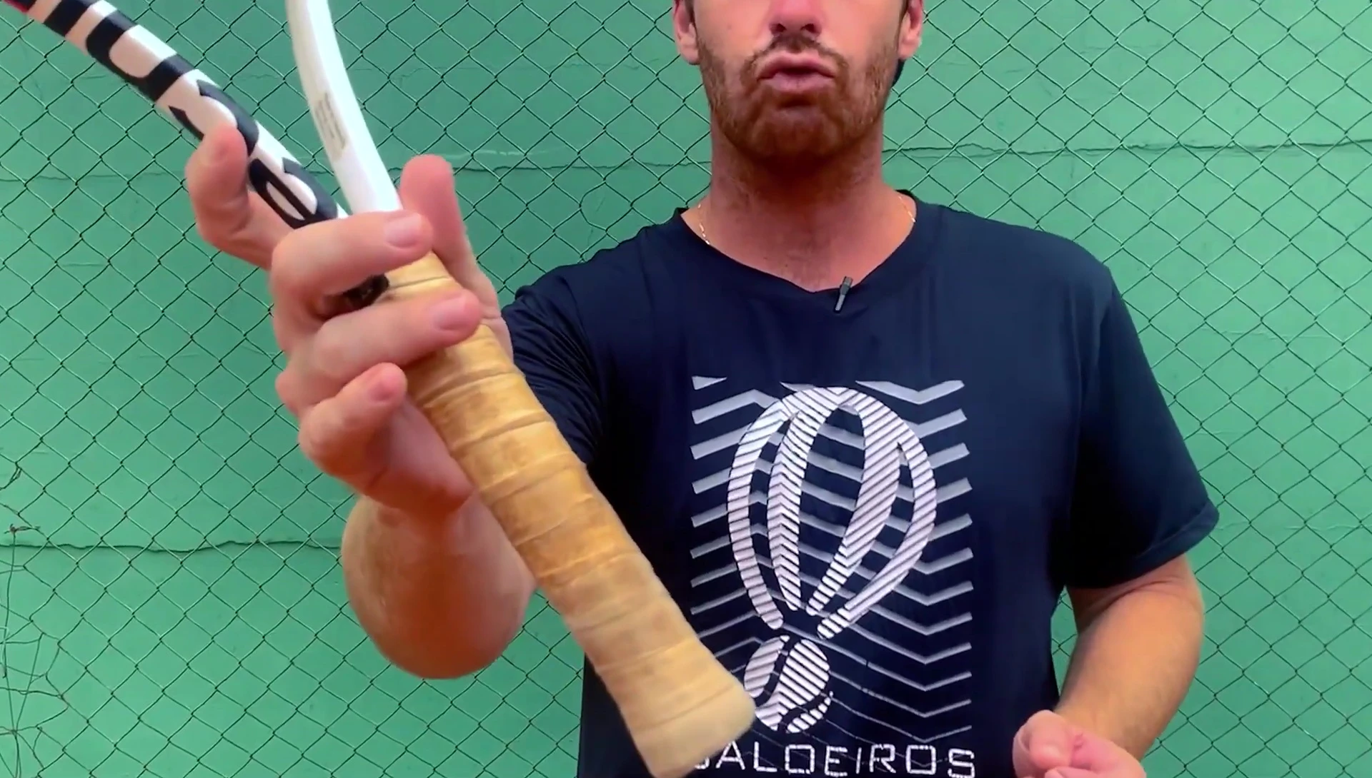 Close-up of the Yonex overgrip on a tennis racket, showcasing its wear after several training sessions.