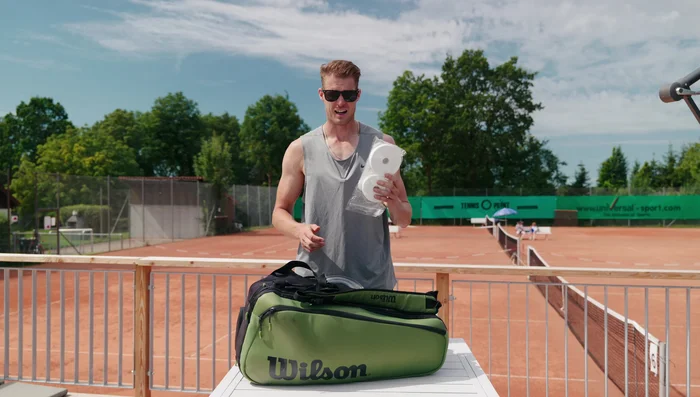 Pack new overgrips for sweaty hands; changing grips before each match is a key routine.